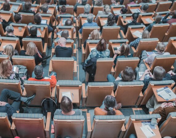 high-angle photography of group of people sitting at chairs